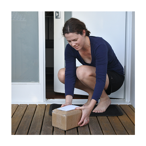 Woman grabbing a package that has been delivered