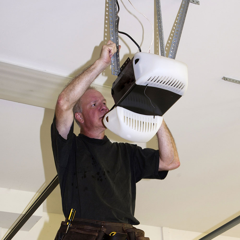 a person fixing a ceiling mounted light fixture a person fixing a ceiling mounted light fixture