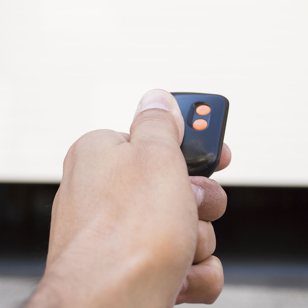 a hand holding a remote control