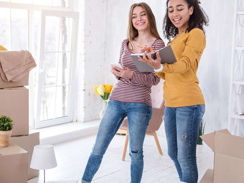 Two girls looking and smiling