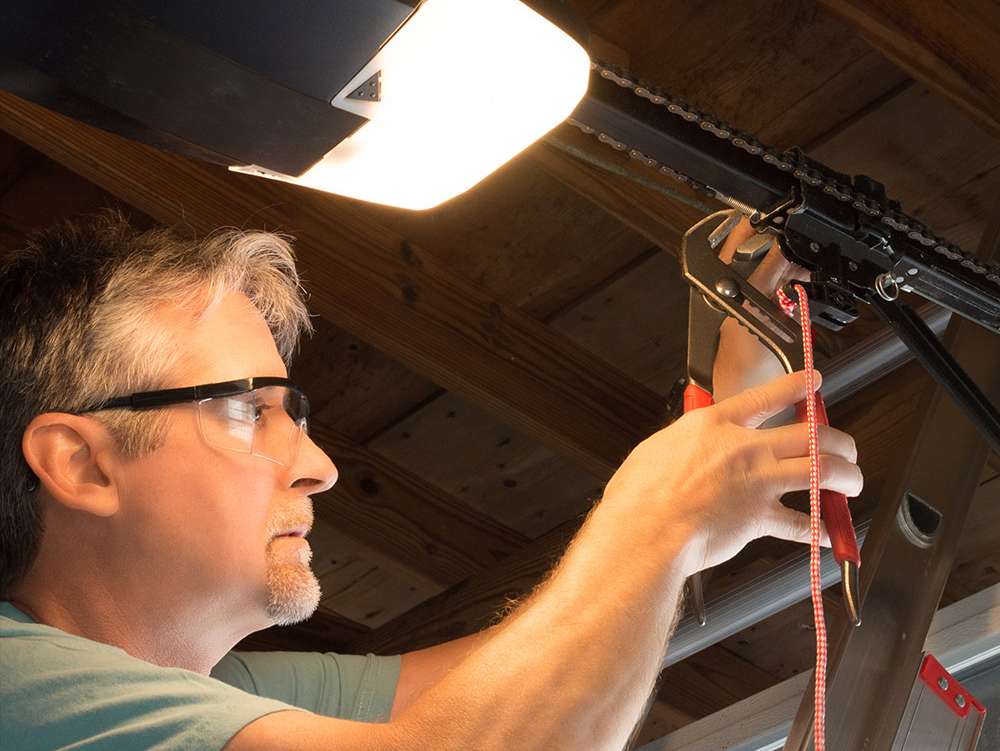 a person working on a light fixture a person working on a light fixture